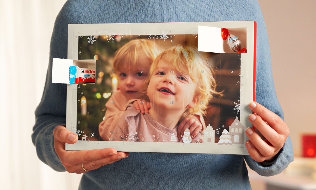 Una persona tiene una cornice festiva con una bella foto e elementi decorativi, ideale per ricordi personali.